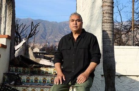 Ian White, an artist, against a burned house across from the park named for his celebrated father, the painter Charles White. The staggering loss of heritage has served as a grim reminder to the community to protect and cherish what’s left.Credit...Magdalena Wosinska for The New York Times